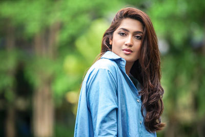 Portrait of young woman standing outdoors