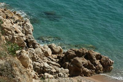 High angle view of rocks at sea shore