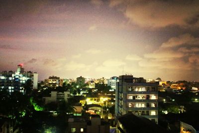 Buildings against cloudy sky