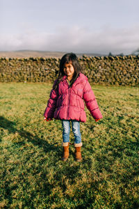 Full length of girl on field against sky