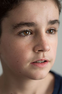 Close-up of teenage boy looking away