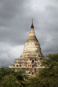 View of temple building against cloudy sky