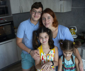 Happy family smiling in the kitchen at home