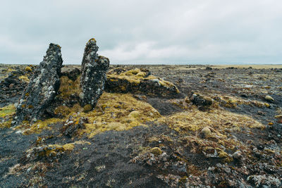 Scenic view of rock formation in sea against sky