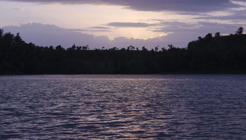 Scenic view of lake against sky at sunset