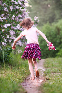 Full length of girl running on field