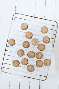 Directly above shot of oatmeal cookies on cooling rack at table