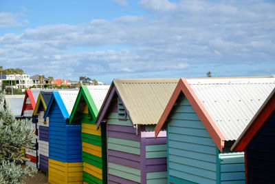 Multi colored houses on beach against sky