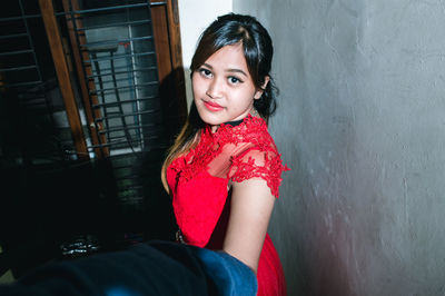 Portrait of smiling girl sitting at home