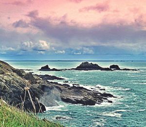 Scenic view of sea against cloudy sky