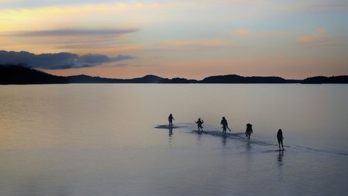 Silhouette of children at the seaside during sunset