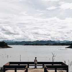 Man looking at view while standing against sky