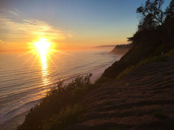 Scenic view of beach against sky during sunset