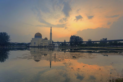 Reflection of mosque on lake during sunset