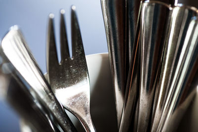 Close-up of silverware in container