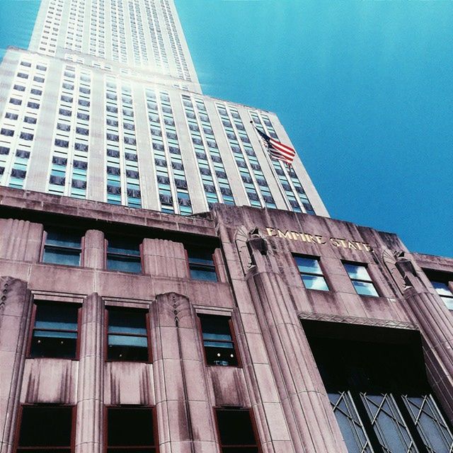 architecture, built structure, low angle view, building exterior, window, clear sky, city, blue, modern, building, glass - material, office building, tall - high, tower, sky, day, no people, outdoors, architectural feature, famous place