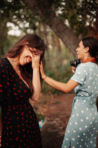 Young smiling lesbian couple standing outdoors