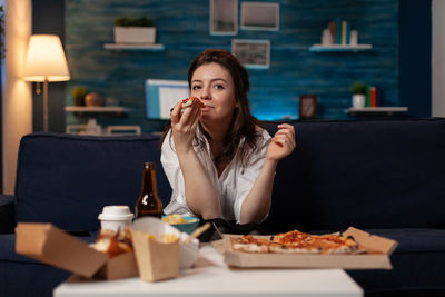 Young woman using mobile phone at restaurant