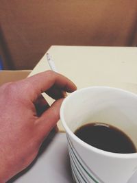 Person holding coffee cup