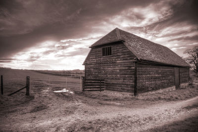 Abandoned house on field against sky