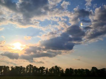 Silhouette trees against sky during sunset