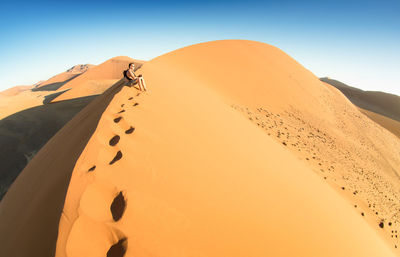 Scenic view of desert against clear sky