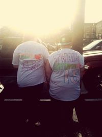 Rear view of people standing in city