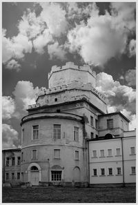 Low angle view of building against cloudy sky