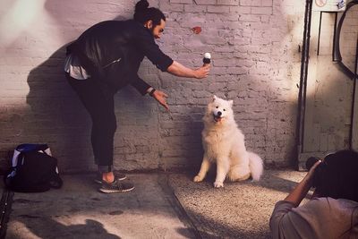 Full length of man standing with dog