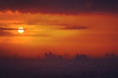 Silhouette of city during sunset