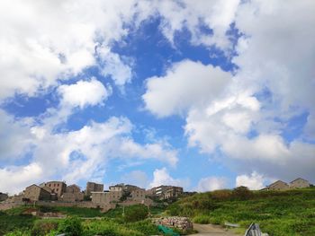 Buildings against cloudy sky