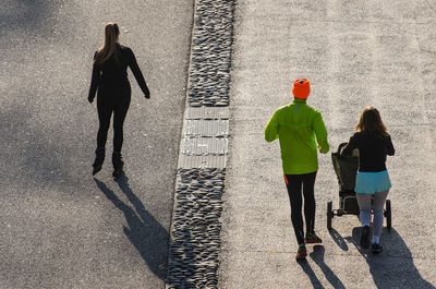 Rear view of people walking on street