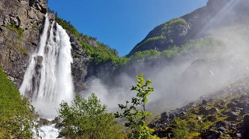 Low angle view of waterfall against sky