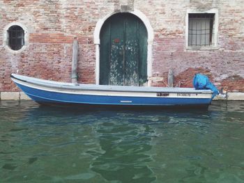 Boats in river with buildings in background