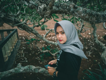 Portrait of young woman standing outdoors