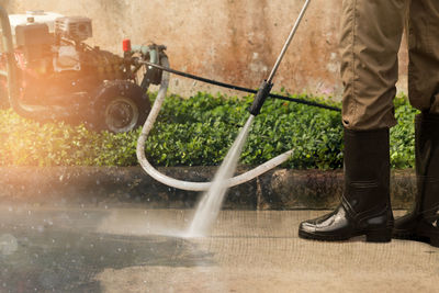 Low section of man splashing water on floor