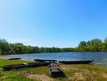 Scenic view of calm lake against clear blue sky