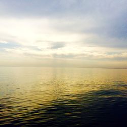 Scenic view of sea against cloudy sky