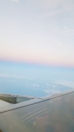 Airplane flying over landscape against sky