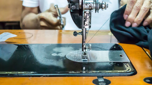 Close-up of tailor using sewing machine