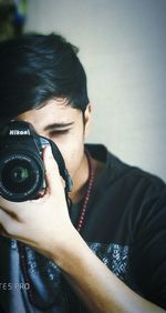 Portrait of young man photographing