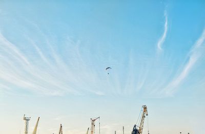 Low angle view of person paragliding against sky