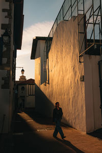 Side view of man walking on street in abandoned house