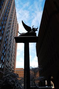 Low angle view of statue against sky