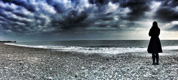 Scenic view of sea against cloudy sky