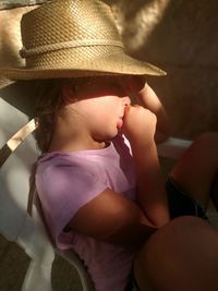 Close-up of cute baby girl sitting on sofa