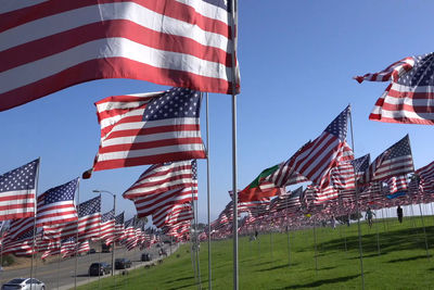 Flags against sky in city