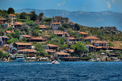 View of townscape by sea against sky