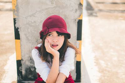 Woman looking away while sitting on terrace