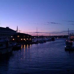 Boats in river at dusk